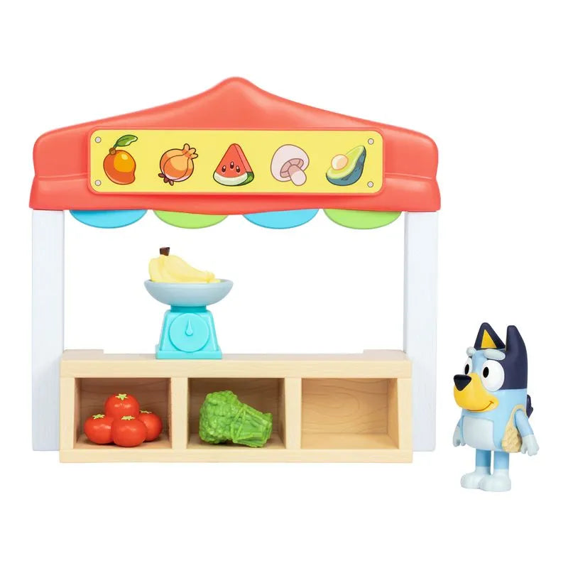 Puente de frutas de madera multicolor con figura azul en mercado de juguetes